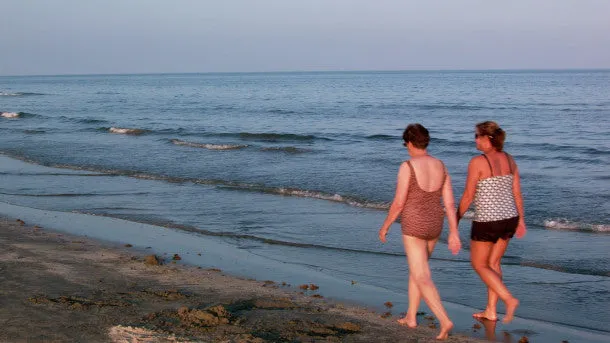 Women Walk on Beach